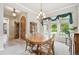 Inviting dining room with ample natural light, a classic chandelier, and neutral décor at 4775 S Anaheim Ct, Aurora, CO 80015