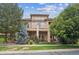 Elegant exterior showcasing a multi-story home with well-manicured landscaping, balconies, and a welcoming facade at 4775 S Anaheim Ct, Aurora, CO 80015