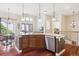 Spacious kitchen area with a large island, stainless steel appliances, and hardwood floors, perfect for entertaining at 4775 S Anaheim Ct, Aurora, CO 80015