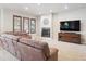 Comfortable living room with fireplace, TV, and lots of natural light at 4775 S Anaheim Ct, Aurora, CO 80015