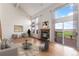 Bright and airy living room features high ceilings, a fireplace, and deck access at 4603 S Abilene Cir, Aurora, CO 80015