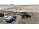 Wide aerial view of a home with a detached garage and vehicles in a rural environment surrounded by farmland at 7440 S Shenandoah Dr, Elizabeth, CO 80107