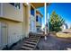 Back porch of a two-story home featuring steps, potted plants, and a hay bale barrier at 7440 S Shenandoah Dr, Elizabeth, CO 80107