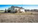 Expansive backyard view featuring a two-story home with a deck and a separate hot tub area at 7440 S Shenandoah Dr, Elizabeth, CO 80107