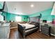 Unique basement bedroom with dark wood floors, colorful walls, and accent lighting at 7440 S Shenandoah Dr, Elizabeth, CO 80107