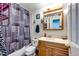 Standard bathroom with a patterned shower curtain and wood vanity at 7440 S Shenandoah Dr, Elizabeth, CO 80107