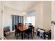 Well-lit dining area with modern chandelier, table with chairs and an adjacent playroom at 7440 S Shenandoah Dr, Elizabeth, CO 80107