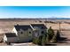 A two-story home on a large lot with mountain views in the background under a bright blue sky at 7440 S Shenandoah Dr, Elizabeth, CO 80107