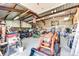 Large, organized garage filled with tools, tractors, and other equipment at 7440 S Shenandoah Dr, Elizabeth, CO 80107