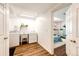 Bright laundry room with laminate flooring and a utility sink, leading into a colorful bedroom space at 7440 S Shenandoah Dr, Elizabeth, CO 80107