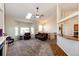 A vaulted ceiling living room with multiple windows, a ceiling fan, and an adjacent staircase at 7440 S Shenandoah Dr, Elizabeth, CO 80107