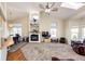 Bright living room featuring a fireplace, vaulted ceilings, and large windows, seamlessly flowing into the dining area at 7440 S Shenandoah Dr, Elizabeth, CO 80107