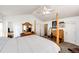 A bright main bedroom features a four-poster bed, a vaulted ceiling with fan, and ensuite bathroom at 7440 S Shenandoah Dr, Elizabeth, CO 80107