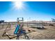 Backyard with a playground and trampoline with beautiful blue skies at 7440 S Shenandoah Dr, Elizabeth, CO 80107