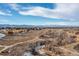 Wide aerial shot of walking paths and open space near luxury community with mountain views in the distance at 9228 Sori Ln, Highlands Ranch, CO 80126