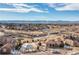 Expansive aerial view of a luxury community showing the pool house, walking paths, and mountain views in the distance at 9228 Sori Ln, Highlands Ranch, CO 80126