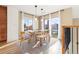 Bright dining area with a glass top table, seating for six and large windows with natural light at 9228 Sori Ln, Highlands Ranch, CO 80126