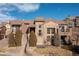 Beautiful multi-story townhome exterior featuring stone accents, arched windows, and well-maintained landscaping at 9228 Sori Ln, Highlands Ranch, CO 80126