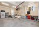 Spacious garage featuring a workbench, a couch, ample storage, and an automatic garage door opener at 9228 Sori Ln, Highlands Ranch, CO 80126