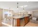 Modern kitchen with stainless steel appliances and granite counters open to dining and living area at 9228 Sori Ln, Highlands Ranch, CO 80126