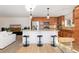 Open concept kitchen with stainless appliances, granite counters and adjacent living area at 9228 Sori Ln, Highlands Ranch, CO 80126