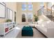 Bright living room with soaring ceilings, large windows, and modern decor at 9228 Sori Ln, Highlands Ranch, CO 80126
