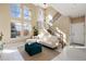 Bright living room with soaring ceilings, large windows, and modern decor at 9228 Sori Ln, Highlands Ranch, CO 80126