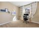 Bright office space featuring plush carpet, neutral walls, and a modern desk setup with natural light from the window at 9228 Sori Ln, Highlands Ranch, CO 80126
