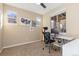 Bright office with three windows, plush carpeting, neutral walls, and a modern desk with black chair at 9228 Sori Ln, Highlands Ranch, CO 80126