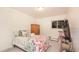 Cozy bedroom with a patterned bedspread, wood armoire, and ample natural light from the window at 5995 W Hampden Ave # 3H, Denver, CO 80227