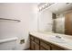 Bathroom featuring a sink, elongated toilet, mirror, and a combination shower-tub with a frosted glass door at 7790 W 87Th Dr # H, Arvada, CO 80005