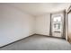 Neutral bedroom with natural light, gray carpet, and access to a built-in closet for ample storage at 7790 W 87Th Dr # H, Arvada, CO 80005