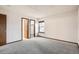 Spacious bedroom with gray carpet, a closet, and a view to an adjacent bathroom for convenience at 7790 W 87Th Dr # H, Arvada, CO 80005