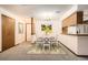 Cozy dining area with a round table, seating for four, and access to the kitchen at 7790 W 87Th Dr # H, Arvada, CO 80005