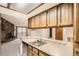 Kitchen countertop space looks out into the living room with fireplace and sliding door access to the patio at 7790 W 87Th Dr # H, Arvada, CO 80005