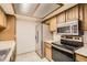 Efficient kitchen space boasting stainless steel appliances and light wood cabinetry at 7790 W 87Th Dr # H, Arvada, CO 80005