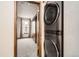Laundry area with stacked washer and dryer units adjacent to a bedroom space at 7790 W 87Th Dr # H, Arvada, CO 80005