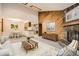 Inviting living room featuring a stone fireplace and wood accent wall, perfect for cozy evenings at 7790 W 87Th Dr # H, Arvada, CO 80005