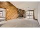 Spacious living room with stone fireplace, wood accent wall, and access to an outdoor balcony at 7790 W 87Th Dr # H, Arvada, CO 80005
