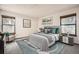 Serene bedroom with accent wall, windows with natural light, and stylish furnishings at 7790 W 87Th Dr # H, Arvada, CO 80005