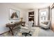 Office showcasing a desk, sitting area, and large window providing natural light for a workspace at 7790 W 87Th Dr # H, Arvada, CO 80005