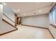 Spacious basement with neutral carpet, base molding, with stairway access to upper floors at 16247 E Belleview Pl, Centennial, CO 80015