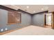 Basement featuring carpet flooring, neutral paint, window with blinds, and a closet with shelving at 16247 E Belleview Pl, Centennial, CO 80015