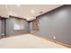 Basement featuring carpet flooring, neutral paint, and a window with blinds, providing ample natural light at 16247 E Belleview Pl, Centennial, CO 80015