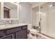 Bathroom featuring updated vanity, a mosaic backsplash, and a convenient walk-in shower at 16247 E Belleview Pl, Centennial, CO 80015