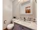 Half bathroom with vanity, mirror, and toilet at 16247 E Belleview Pl, Centennial, CO 80015