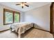 Bedroom with neutral walls, carpet floors, ceiling fan, and natural light from a large window at 16247 E Belleview Pl, Centennial, CO 80015