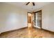 Bedroom featuring hardwood floors, closet, and view to the next room at 16247 E Belleview Pl, Centennial, CO 80015