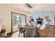 Open concept dining room features wood floors and access to the outdoor patio at 16247 E Belleview Pl, Centennial, CO 80015