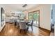 Open concept kitchen and dining area featuring wood floors and natural light at 16247 E Belleview Pl, Centennial, CO 80015